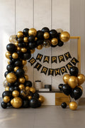 Black and gold birthday decoration set with black, metallic gold and confetti balloons and happy birthday banner