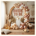 Boho Bride Bliss decoration theme with neutral balloon arch, pampas grass and elegant bridal shower backdrop