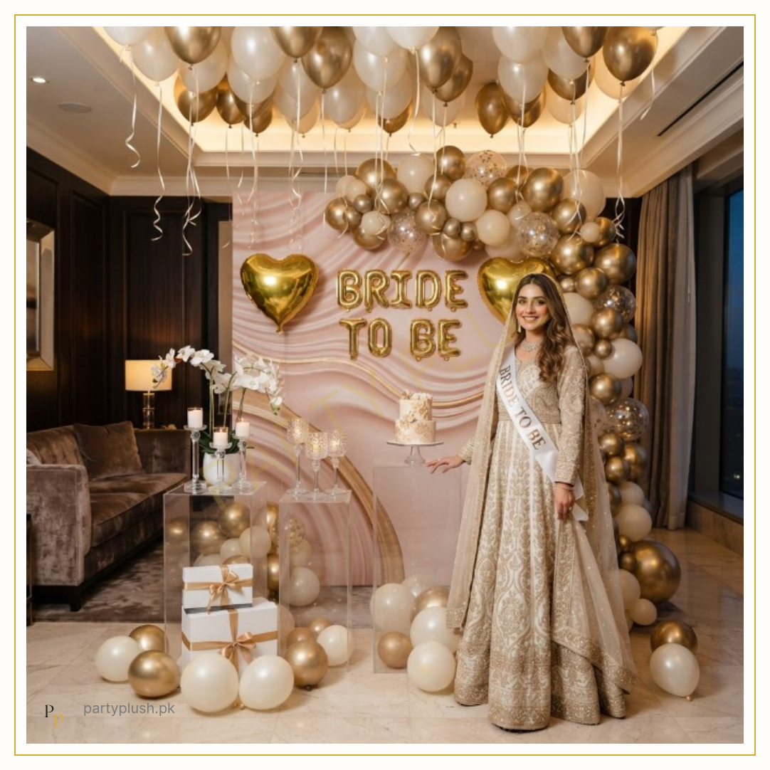 Golden Noor Bride decoration with gold, white and champagne balloon arch, Bride To Be gold foil letters, gold heart foil balloons and elegant bridal shower setup.