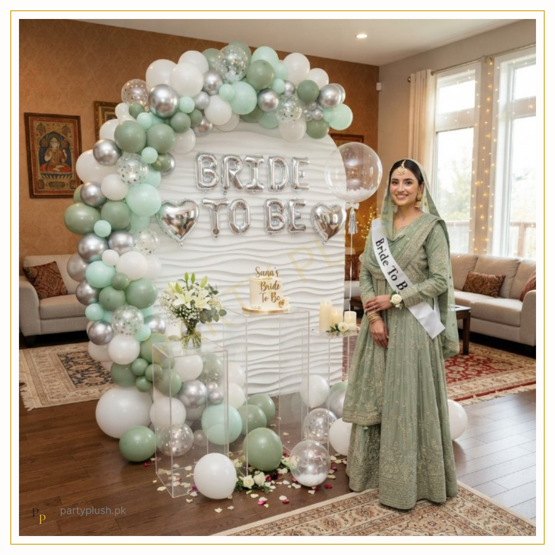 Mint green and white Bride To Be decoration with silver chrome balloons, balloon arch, silver heart foil balloons and elegant bridal shower setup.