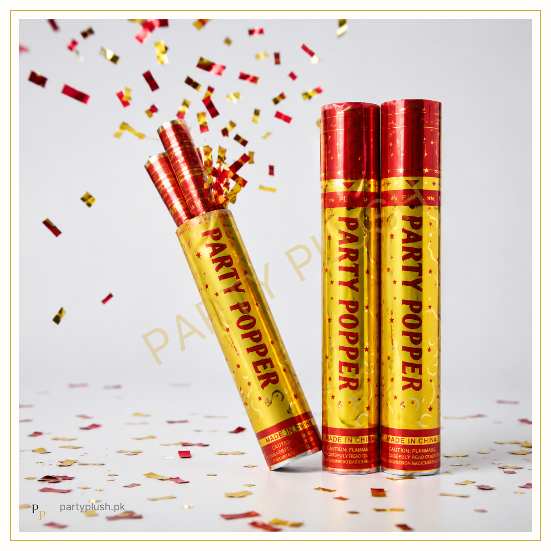 Party popper confetti cannon with red and gold metallic confetti for celebrations