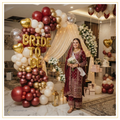 Sindhi Royal Bride decoration with maroon, red, gold and ivory balloon arch, gold Bride To Be foil letters, premium floral décor and elegant bridal shower backdrop.
